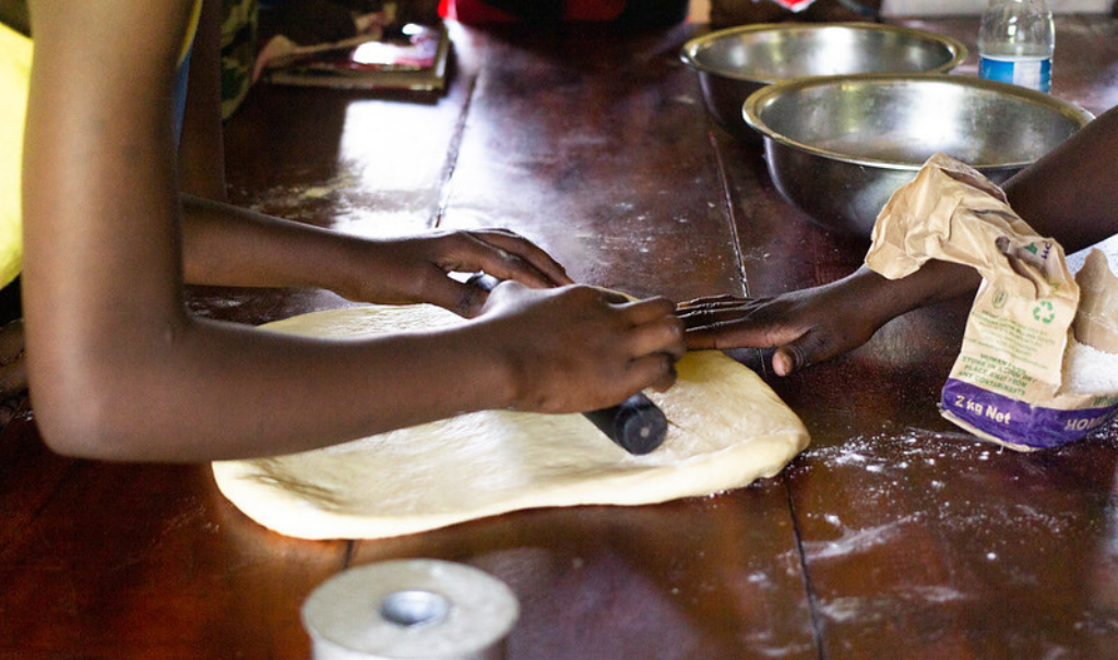 Survivors in Uganda practice catering skills during vocational training