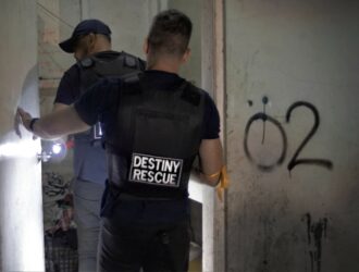 Agents cautiously enter a building during a raid