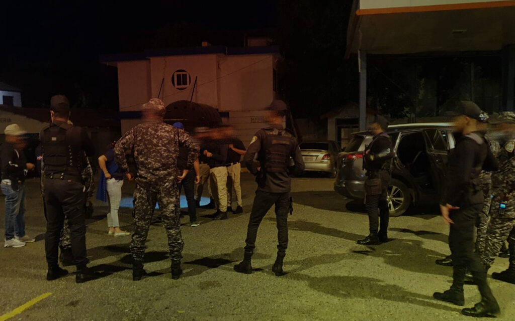 Police and Destiny Rescue agents gathered during a raid