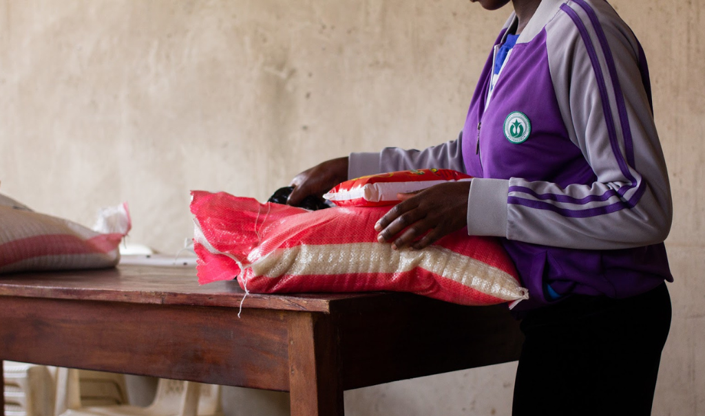 A survivor in Uganda receives a food pack as part of her Freedom Plan