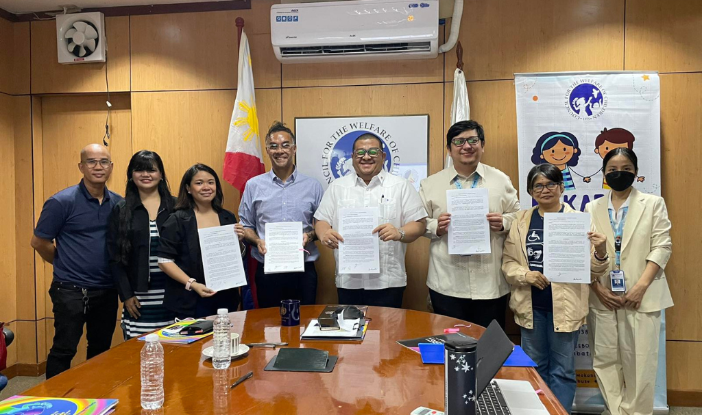 Alwin Laysico (fourth from right) and Undersecretary Angelo Tapales (fifth from right) stand with their respective teammates after the MOU is signed