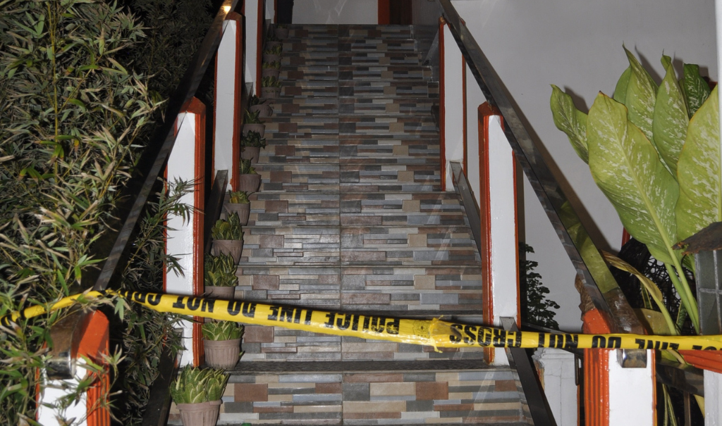 Police tape covers the entrance to a location in the Philippines where 23 young women and girls were rescued in 2022